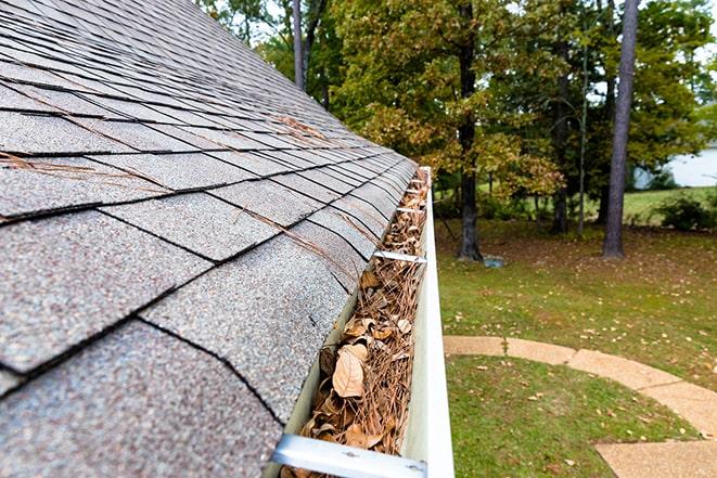 a house with a clean gutter after maintenance